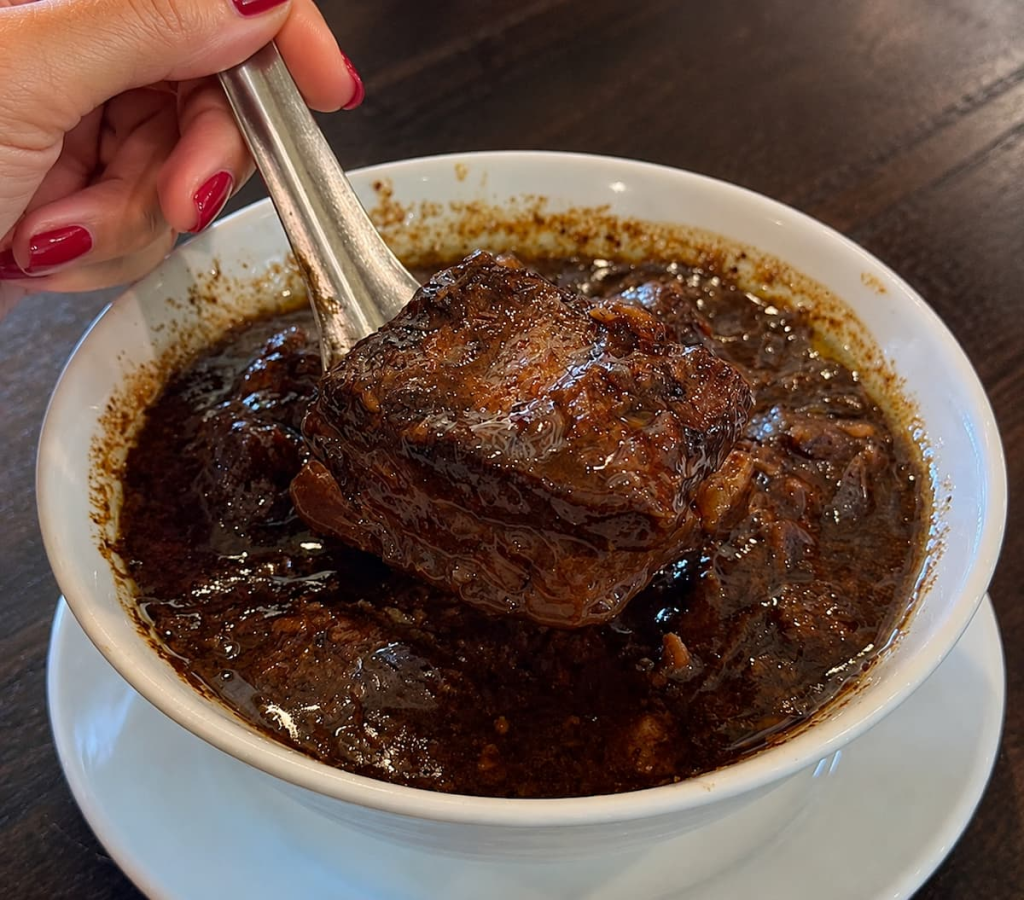 Phuket-style moo hong with tender pork belly in a dark peppery sauce, featured in our Phuket travel guide.
