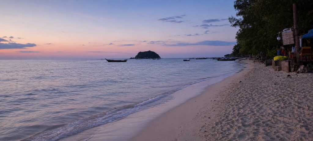 Early morning light and longtail boats along Sunrise Beach on Koh Lipe