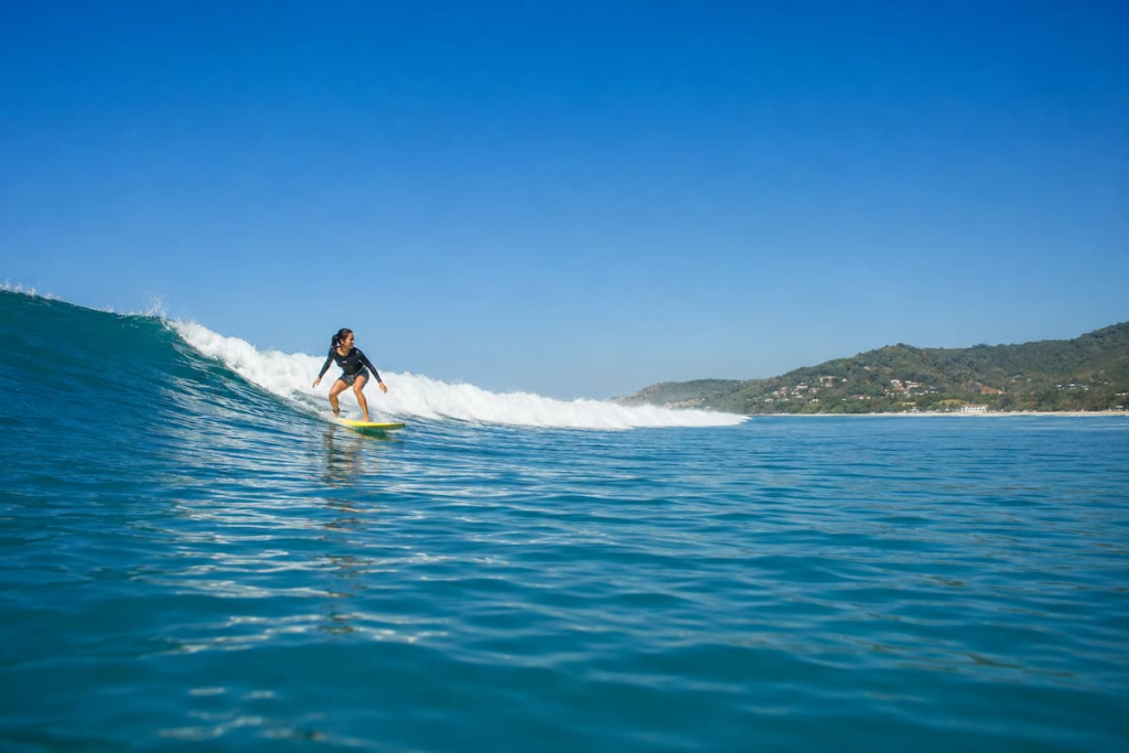 Surfer riding a wave at Kata Beach in Phuket during Southern Thailand’s surf season.