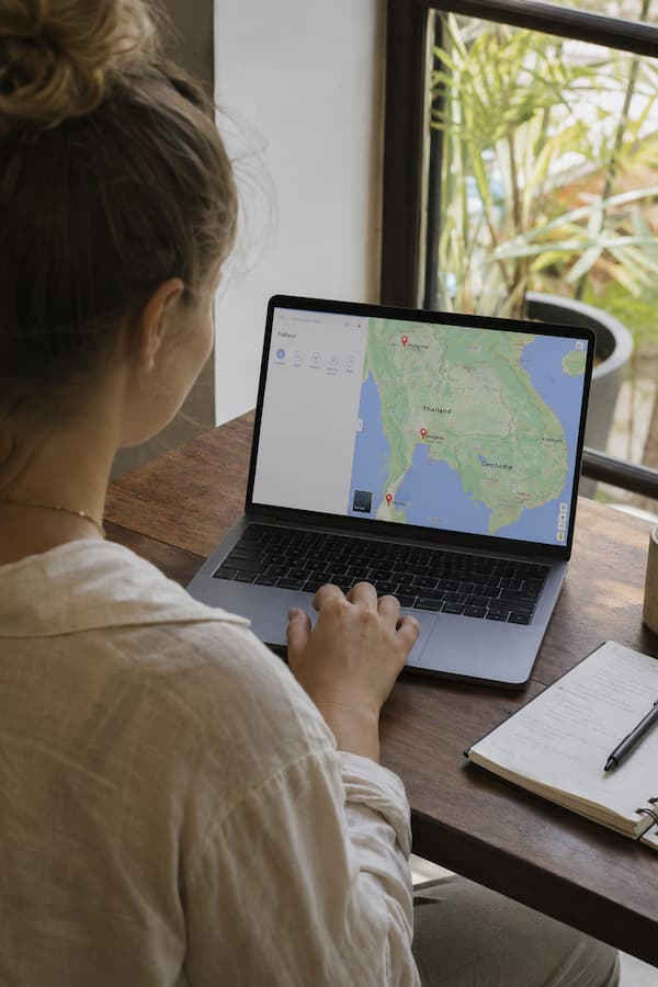 Traveller using Google Maps to choose where to go in Thailand while planning a Thailand travel guide itinerary.