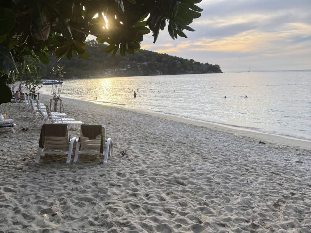 Visitors relaxing on Tri Trang Beach at sunset near Patong, featured in our Patong Travel Guide.
