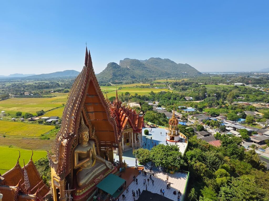 Wat Tham Suea overlooking rice fields and mountains in Kanchanaburi