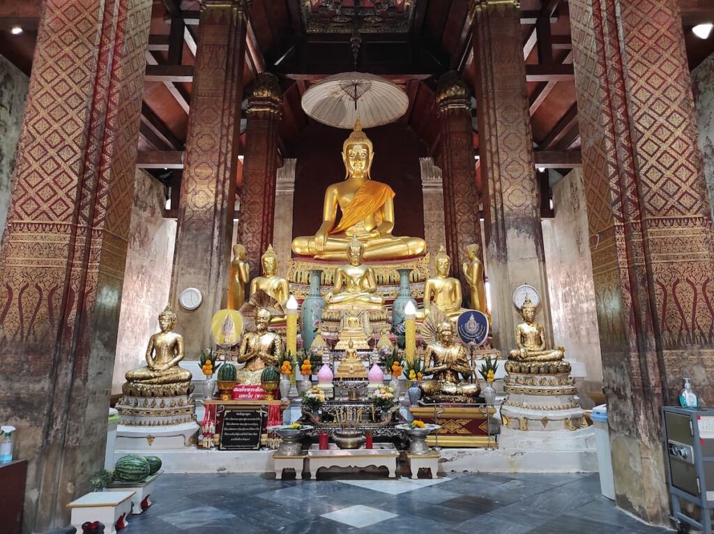 Golden Buddha statues inside Wat Yai Suwannaram in Phetchaburi, featured in where to go in Central Thailand.