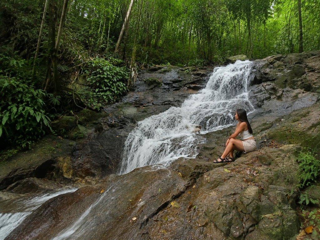 Kathu Waterfall surrounded by tropical forest, showing Phuket beyond its beaches and resort areas.