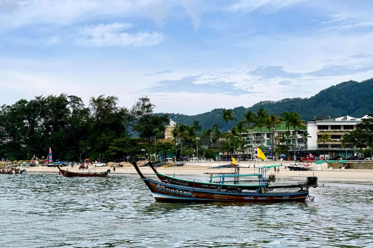 Longtail boat on Patong Beach in Phuket for a guide to how much a holiday in Patong costs