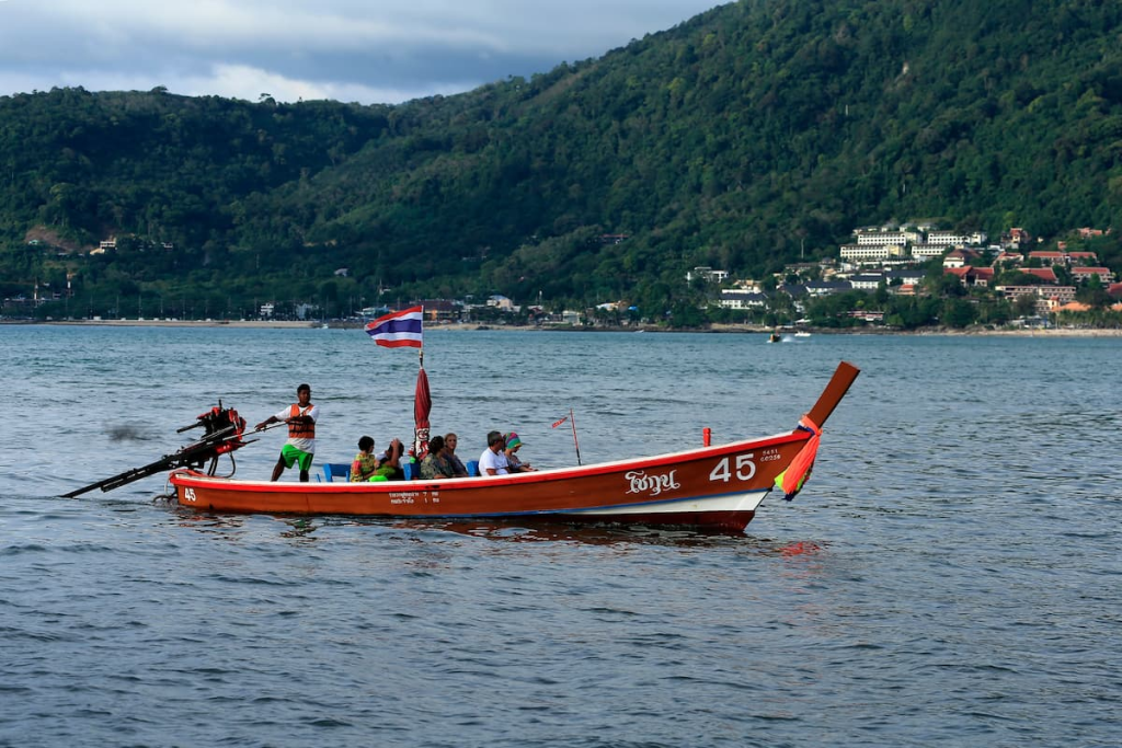 Travel to Phuket with a longtail boat carrying passengers from Rawai to islands off Phuket’s southern coast